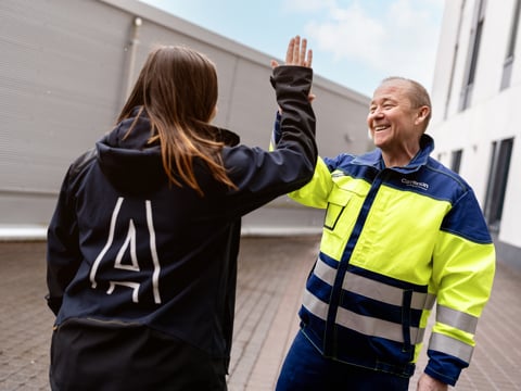 Two employees giving each other a high five